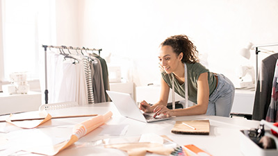 Mujer costurera haciendo trabajos en su notebook