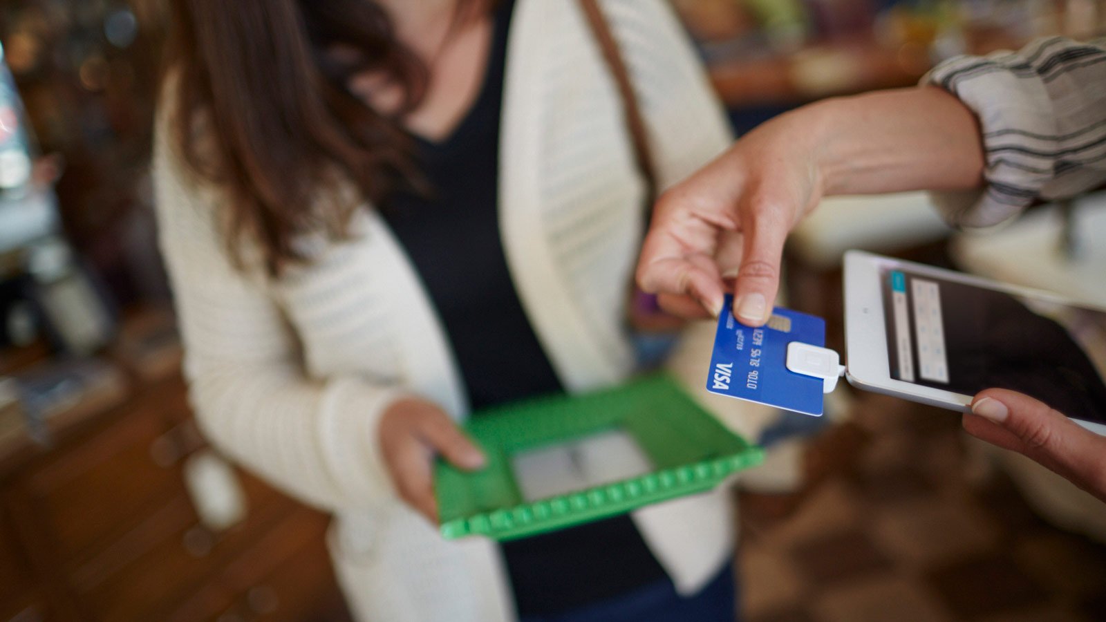  Person swiping a Visa credit card with a mobile card reader.
